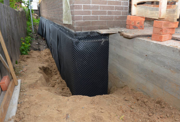 Happy homeowners after waterproofing job in Attica